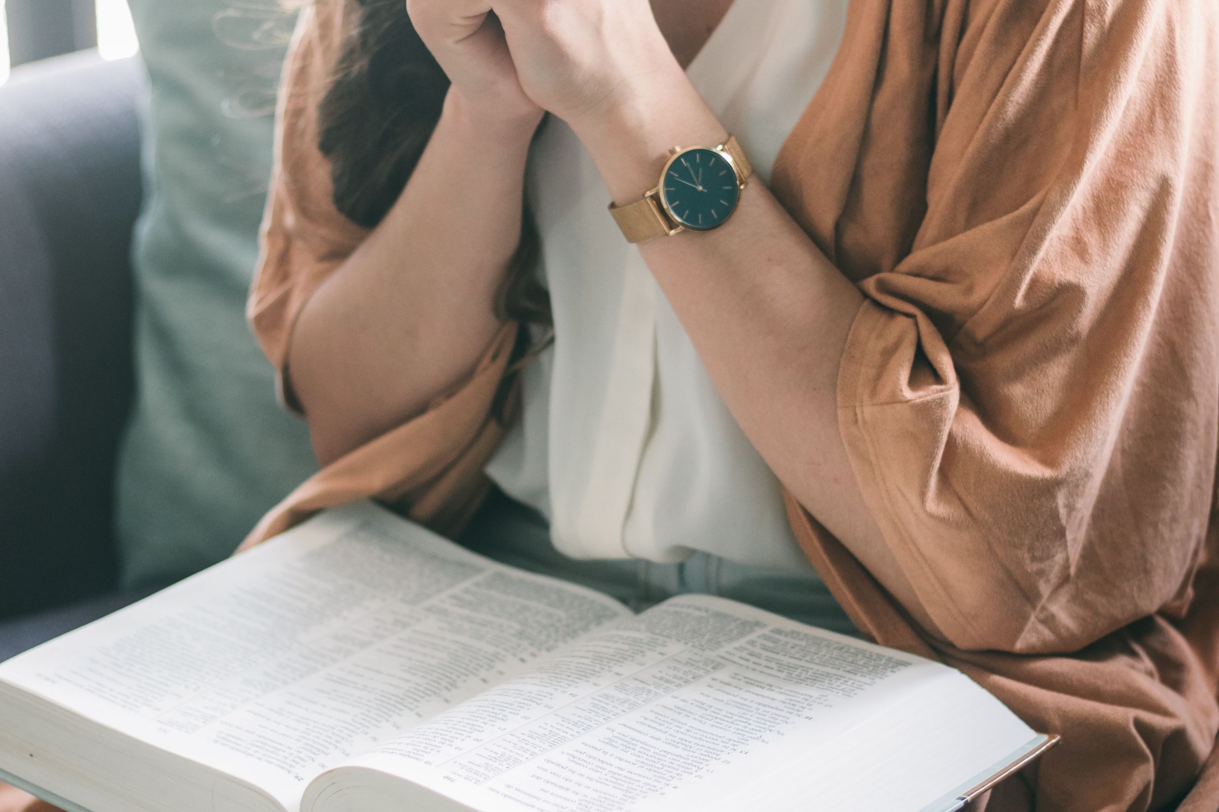 Women reading her Bible and praying at home